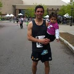 Marco Bitran holding child at a race