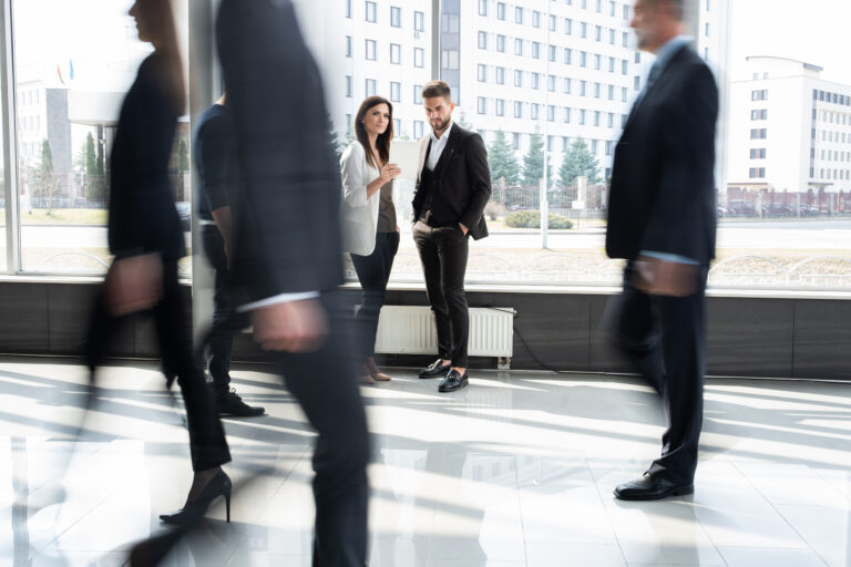 White collar workers going down office corridor during working day